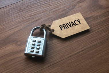 A padlock with number attached to a tag written with Privacy.