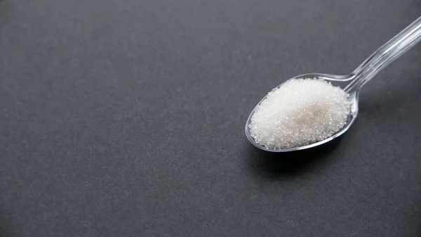 White Sugar Transparent Spoon Black Background Copy Space —  Fotos de Stock