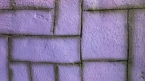 Purple brick or stone texture of a wall.
