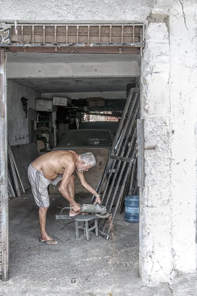 Äldre metallarbetare i sitt garage — Stockfoto