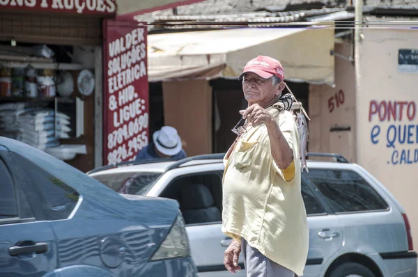 Elderly fisherman in the street — Stock Photo, Image