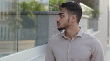 Erkek tüketicinin portresi caddede yürürken vitrinlere bakıyor ve seçim yapıyor. Hispanik sakallı bir iş adamı şehirde yürürken Arap turistlerin yeni bir şehre gideceğini düşünür.