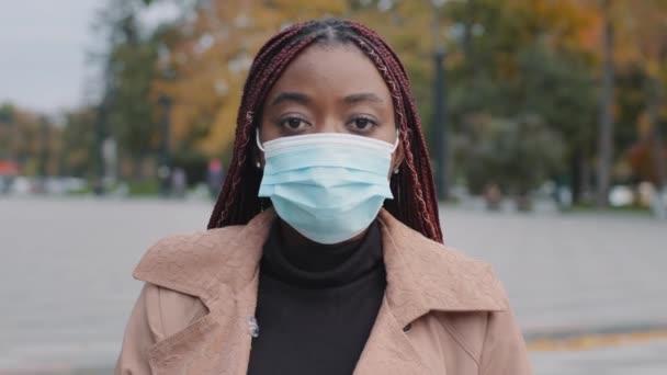 Portret afrykańskiej kobiety w masce chroniącej przed wirusem korony. Milenium afro kobieta w twarz przeciwko covid-19. Ochrona zdrowia, koronawirus, opieka zdrowotna w czasie kwarantanny. — Wideo stockowe