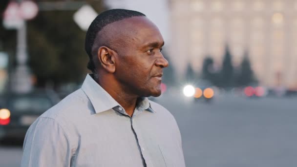 Portrait confident experienced mature american senior businessman smiling happy adult entrepreneur man boss leader wears stylish shirt stands in downtown posing outdoor looking at camera — Stock Video