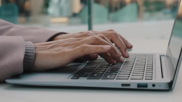 Close-up female manicured hands unknown woman typing on laptop keyboard unrecognizable businesswoman secretary manager user enters data using computer application working in office sitting at table — Vídeos de Stock