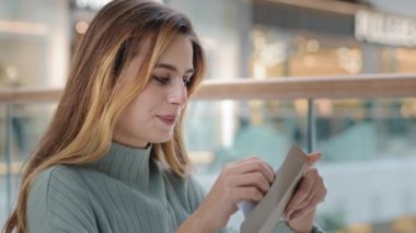 Caucasian woman girl indoors received mail correspondence take out letter from envelope read good pleasant news have invitation happy with bank loan approved positive result winning career growth