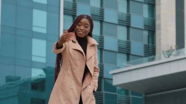 Happy friendly smiling attractive young african american woman business lady manager stretching out waving hand, making hello gesture, welcoming friend partner client at meeting, acquaintance concept