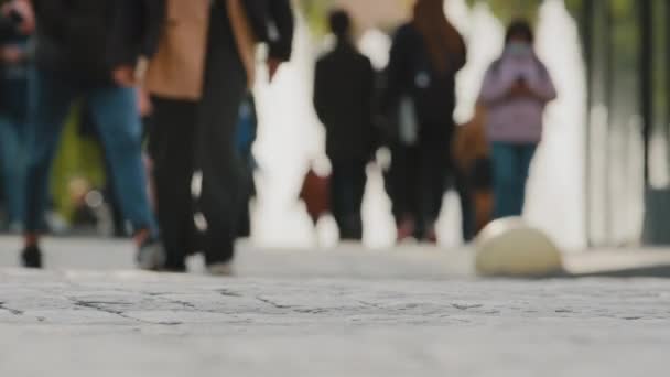 Human feet closeup walking outside on street, crowd many legs moving in downtown, urban busy lifestyle bustle casual focus, worldwide traveling. Diverse people walk, pedestrians crossing road — Wideo stockowe