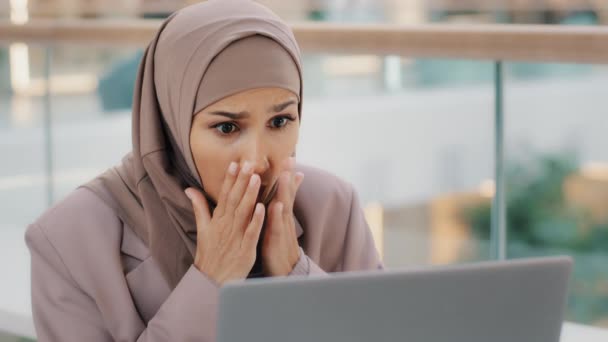 Sorglig muslim flicka student i hijab tittar på bärbar skärm läsa e-post chockad av dåliga nyheter frustrerad affärskvinna bekymmer om ekonomiska problem får misslyckade examen resultat college avhopp förlorat jobb — Stockvideo