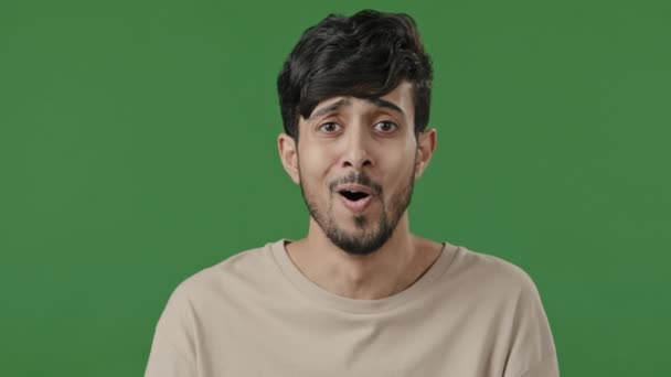 Portrait astonished arab guy open mouth with delight hold head from incredible news feels shock joy amazed man stands in studio with green background looking at camera shows thumb up supports approves — Stock Video