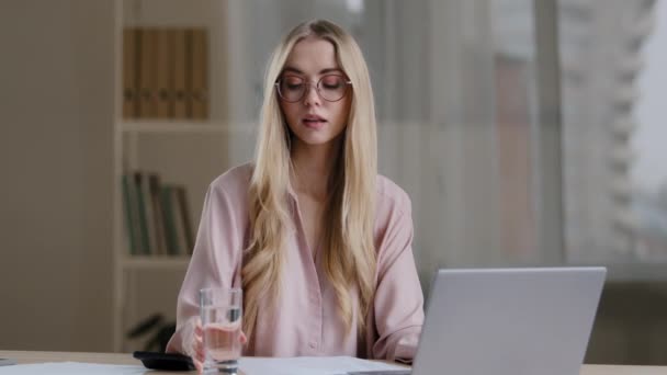 Caucasian busy business woman worker girl female student wearing glasses with laptop paperwork learning feeling thirsty drinking from glass water balance health care diet refreshment daily good habit — Stock Video