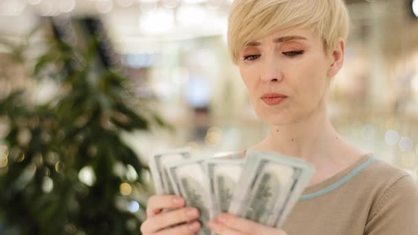 Headshot caucasian middle aged rich woman counting money checking cash salary bonus serious businesswoman with financial payment count bribe holding dollars bills dollar banknotes with lottery income — Stock Video