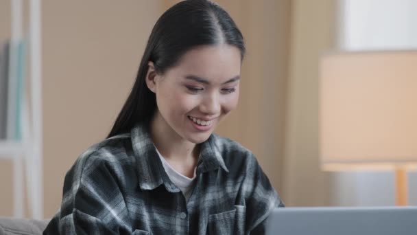 헤드 샷 asian 여학생 프리랜서 사업가 사업가 여성 이 인터넷에서 일하는 여성 전문가에게 pc 기술을 사용하여 노트북 컴퓨터로 타이핑하는 모습, 집에서 인터넷 검색을 하며 행복하게 웃는 모습. — 비디오