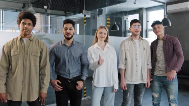 Happy professional confident group diverse people corporate employees standing in row looking at camera smiling showing thumbs up best appreciation gesture approval agreement sign great recommendation — Stock Video