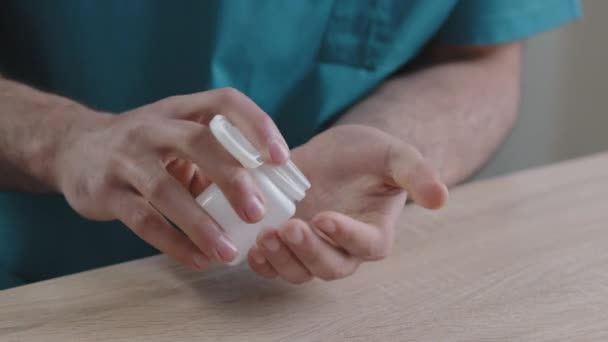 Close up body part of unknown man doctor patient putting painkiller pills in male hand from meds bottle taking vitamins with glass water doctors prescription improve human immunity treatment concept — Stock Video