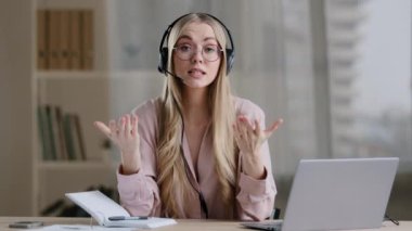 Kadın yardım hattı yöneticisi danışman danışman eğitmen uzaktan öğretmen eğitmen kulaklıklı hoca havadaki jestleri göstererek online brifing rehberi görüntülü konuşma konferansı yardımını uzaktan öğreniyor.