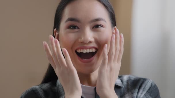 Close up surprised female face oh my god wow expression amazed excited asian happy woman looking at camera shocked by victory triumph good news euphoric korean girl winning bid getting offer success — 비디오