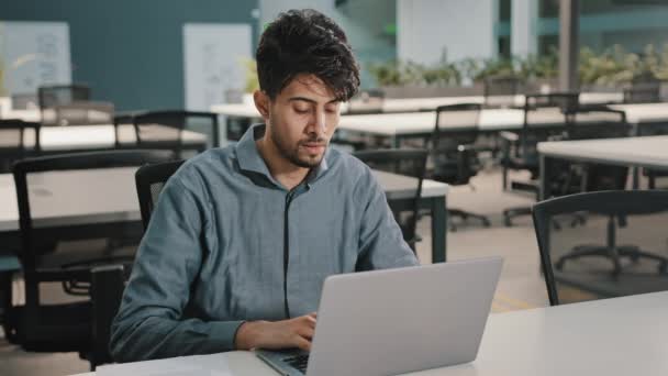 Exhausted stressed arabian young business man employee guy distracted from laptop take break close irritated eyes relieve painful discomfort overworked worker feel headache fatigue after office work — Stock Video