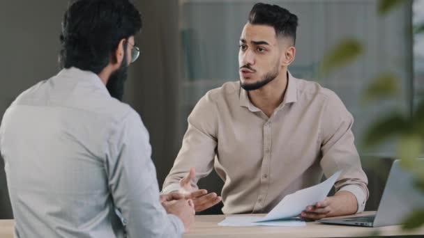 Hispanic young businessman man financial advisor agent lawyer worker consulting unknown male client customer explaining insurance contract benefits negotiating giving business advice at office meeting — Video Stock