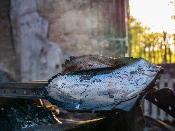 Kharkiv region, Kharkov, Skovorodinovka, Skovorodinivka, Ukraine - 05.07.2022: burning book in literary Skovoroda museum smoldering from fire smoking paper missile attack on ruins war destroyed walls — Stock Photo, Image