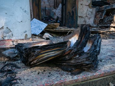 Kharkiv Kharkov region, Skovorodinovka, Skovorodinivka, Ukraine - 05.07.2022: burnt book historical literature in destroyed museum building ash war invasion Russian aggression result rocket attack