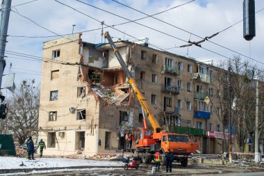 Kharkiv, Ukraine - 05.06.2022: Terrible destroyed building in city street crane dismantling damage house destruction broken due to bombing russian aggression war in Ukraine consequences of bomb rocket