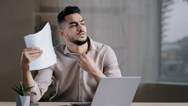 Hispanic exhausted male business man annoyed guy suffer from summer heat in office home without air conditioner feeling hot high air temperature uncomfortable waving papers cooling make wind freshen — Stock Photo, Image