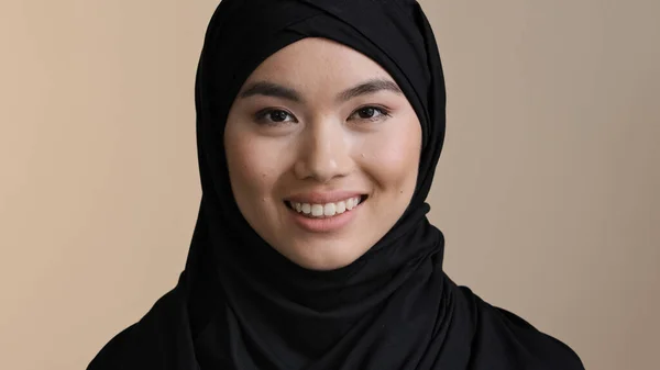 Portrait smiling executive business woman asian muslim islamic girl casual wear hijab looking at camera smile happy in modern office workplace at home. Young lady dental service client laugh toothy