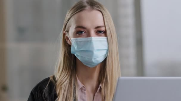 Portrait caucasian masked girl female student businesswoman user in medical protective face mask health insurance shows ok gesture good feeling recovery consent agree symbol everything fine great sign — ストック動画