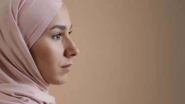 Close up profile portrait face of arab saudi woman muslim lady in stylish headscarf beautiful asian girl model businesswoman wear traditional islamic clothing confident pose look eyesight away indoor
