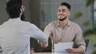 İki başarılı iş adamı iş arkadaşı Arap pazarlamacı erkek müdür el sıkışıyor müşteri ortak proje kabul ediyor ofis toplantısı başarılı ortaklık anlaşması
