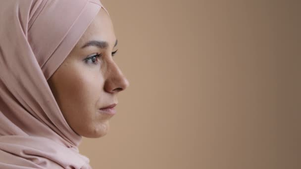 Close up profile portrait face of arab saudi woman muslim lady in stylish headscarf beautiful asian girl model businesswoman wear traditional islamic clothing confident pose look eyesight away indoor — Video