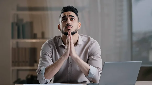 Frustrovaný mladý hispánský mužský analytik náboženský obchodník pocit stresu kontrola finančních dokumentů požádat o pomoc soustředit mysl na problém sedět se zavřenýma očima dát ruce v modlitbě modlí s nadějí — Stock fotografie