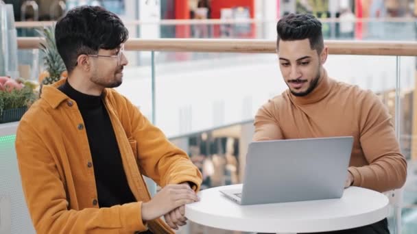 Happy Young Guys Friends Sitting Cafe Arab Man Showing Laptop — Stock videók