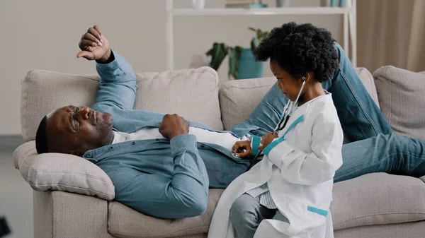 Little Cute Kid Girl Plays Pretending Doctor Adult Father Lies — Foto Stock