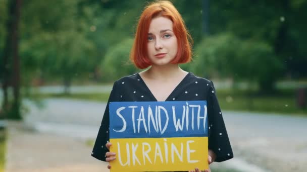 Sad Redhead Girl Hold Cardboard Written Inscription Phrase Stand Ukraine — Stock Video