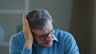 Portrait indoor in office home old thoughtful pensive confused senior man feel worried think memory problem take off glasses forgotten information, elderly old teacher look away anxious about trouble