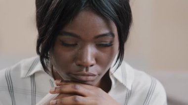 Close-up young african american woman sad worried girl feeling anxious sadness depressed upset female suffering from stress thinking of grief problem psychological disorder lost in depressive thoughts