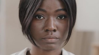 Portrait woman close-up frustrated female face young african american sad girl model with brown eyes looking at camera posing indoors feeling upset disappointed due to discrimination feminism racism