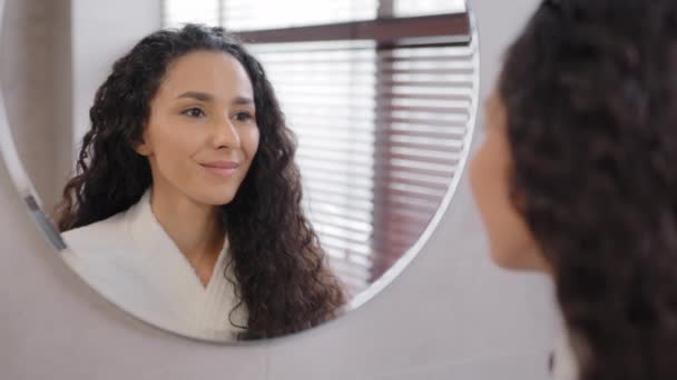 Young Calm Attractive Woman Bathrobe Stands Bathroom Looks Mirror Admiring — Stock Video