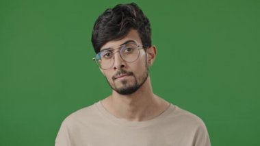 Portrait happy human face male portrait arab indian handsome smart guy smiling looking at camera brunet man freelancer ethnic hispanic model intelligent in trendy eyeglasses posing on green background