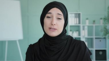 Webcam view Islamic Muslim Indian woman blogger vlogger influencer indoor speaking at camera talking make video conference call online lesson live webinar record lifestyle blog vlog remote web chat