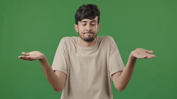 Portrait Puzzled Uncertain Arabic 20S Guy Standing Green Background Unsure — Vídeos de Stock