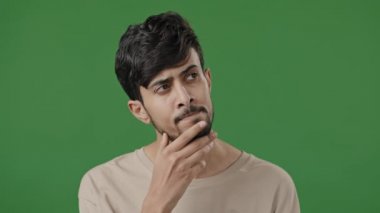 Portrait arabic man stand in green studio thoughtful indian guy pondering create plan search for solution excited make gesture raises finger come up with good idea finds answer feel inspiration eureka