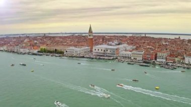 Aerial view of large water canal in Venice old town in Italy ships coastline busy embankment port famous tourist destination historical attraction famed San Marco public square Piazza ancient city