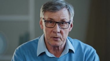 Webcam view old businessman serious conversation talk distant meeting disagree reject reaction mature man looking at the camera talking online senior old 60s male teacher in glasses video class lesson