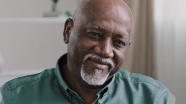 Old bald bearded middle-aged man African grandfather biracial businessman with gray beard looking at camera waving head agree approve good business idea success gesture support raise index finger up