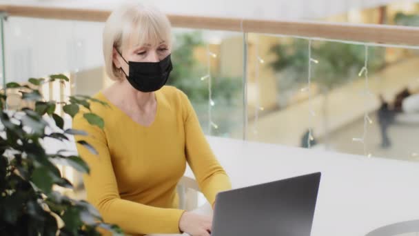 Proud Confident Mature Businesswoman Protective Mask Working Office Typing Laptop — Stockvideo