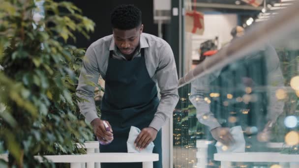 Young Man Waiter Apron Does Cleaning Restaurant Wipes Table Wiping — Αρχείο Βίντεο