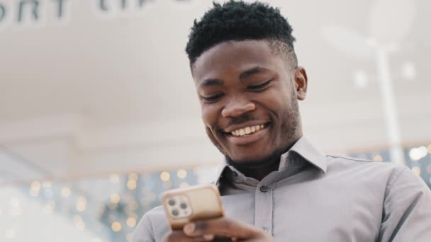 Close Young Happy Man Looking Phone Screen Smiling Enjoying Distance — стоковое видео